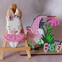 Elegant bunny ballerina iced cookie in pink tutu with bow on wooden stand